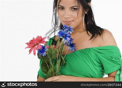 Portrait of a young woman holding flowers