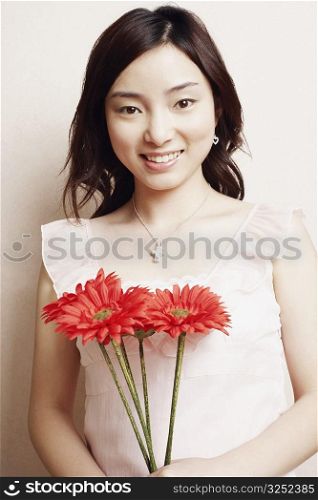 Portrait of a young woman holding flowers