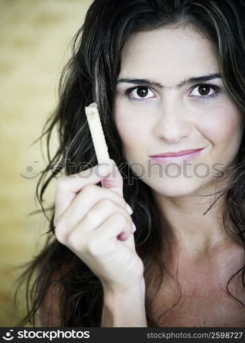 Portrait of a young woman holding snacks and making a face