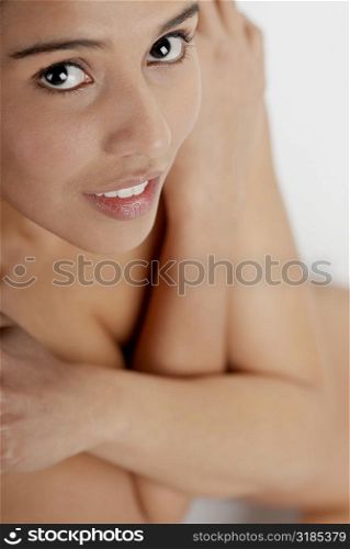 Portrait of a young woman hugging herself