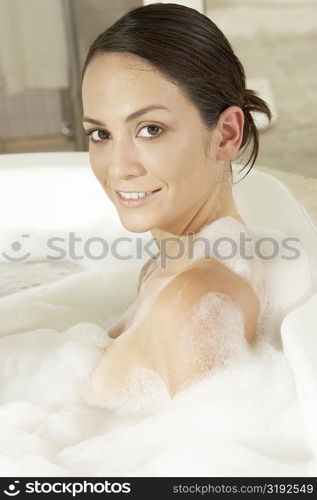 Portrait of a young woman in a bathtub