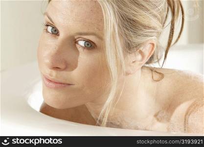 Portrait of a young woman in a bathtub