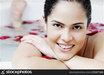 Portrait of a young woman in a bathtub and smiling