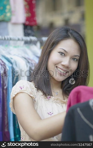 Portrait of a young woman in a clothing store