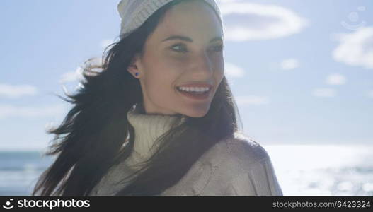 Portrait Of A Young Woman In Autumn Clothes Smiling On The Beach