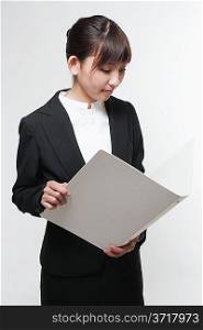 Portrait of a young woman in business suit with a file folder in hand