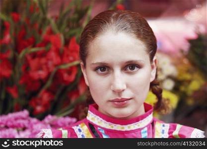 Portrait of a young woman in front of a flower shop