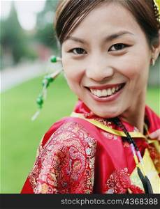 Portrait of a young woman in the traditional clothing smiling
