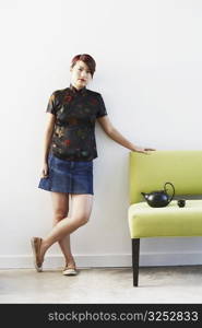 Portrait of a young woman leaning on a couch