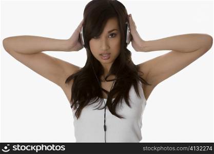 Portrait of a young woman listening to headphones