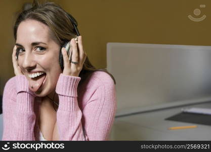 Portrait of a young woman listening to music