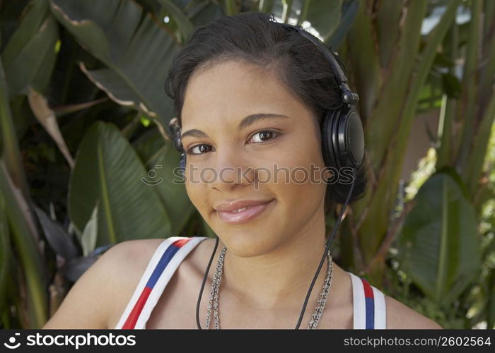 Portrait of a young woman listening to music