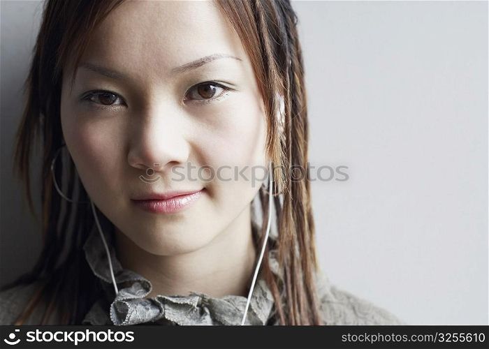 Portrait of a young woman listening to music