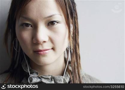 Portrait of a young woman listening to music