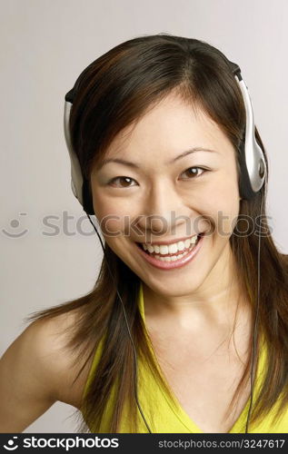 Portrait of a young woman listening to music and smiling