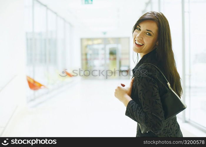 Portrait of a young woman looking back and smiling