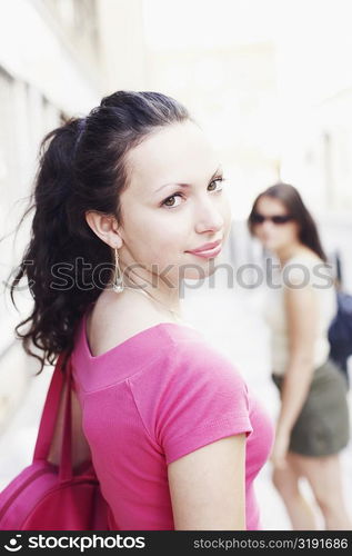 Portrait of a young woman looking over her shoulders