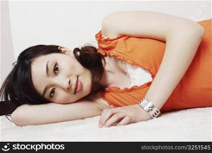 Portrait of a young woman lying down