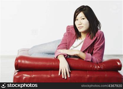 Portrait of a young woman lying down on a mattress