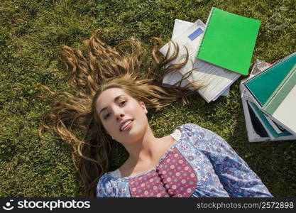 Portrait of a young woman lying on grass