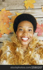 Portrait of a young woman lying on planks