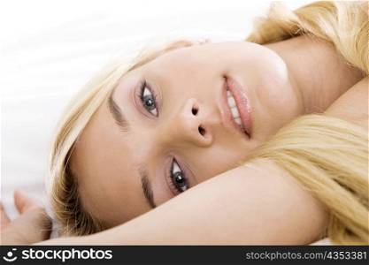 Portrait of a young woman lying on the bed