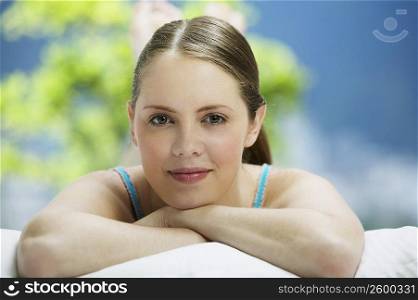 Portrait of a young woman lying on the bed and smiling