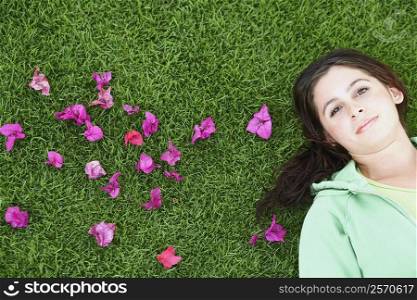 Portrait of a young woman lying on the grass