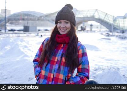 Portrait of a young woman on the background of a winter city