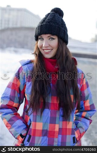 Portrait of a young woman on the background of a winter city
