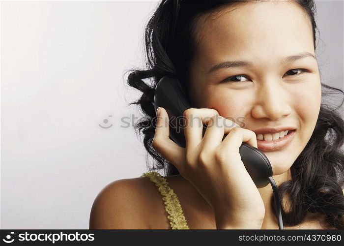 Portrait of a young woman on the phone and smiling