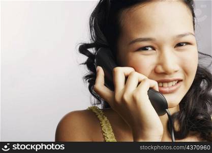 Portrait of a young woman on the phone and smiling