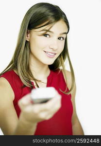 Portrait of a young woman operating a remote control