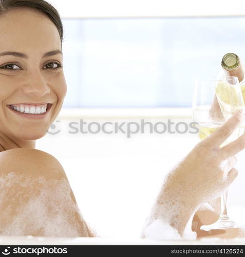 Portrait of a young woman pouring white wine into a wineglass