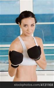 Portrait of a young woman practicing boxing