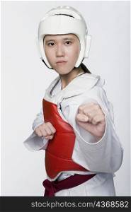 Portrait of a young woman practicing kickboxing