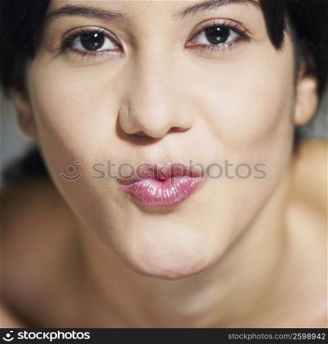Portrait of a young woman puckering