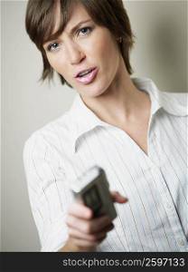 Portrait of a young woman puckering and holding a tape recorder