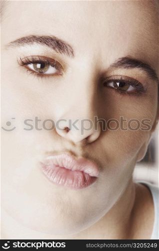 Portrait of a young woman puckering her lips