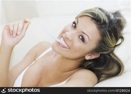 Portrait of a young woman pulling a bubble gum from her mouth