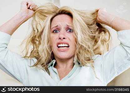 Portrait of a young woman pulling her hair