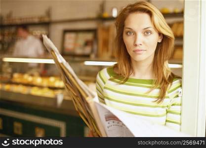 Portrait of a young woman reading a menu card
