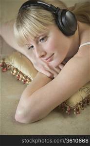 Portrait of a young woman relaxing with headdphones on