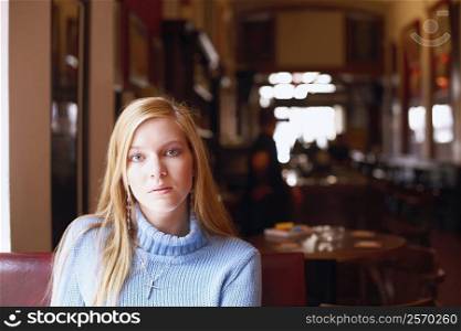 Portrait of a young woman sitting in a restaurant