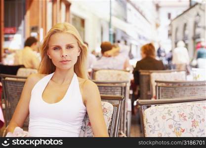 Portrait of a young woman sitting in a restaurant
