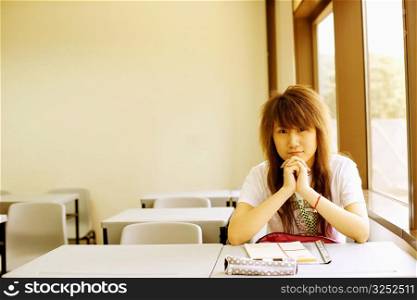 Portrait of a young woman sitting in the classroom
