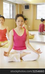 Portrait of a young woman sitting in the lotus position