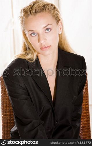 Portrait of a young woman sitting on a chair