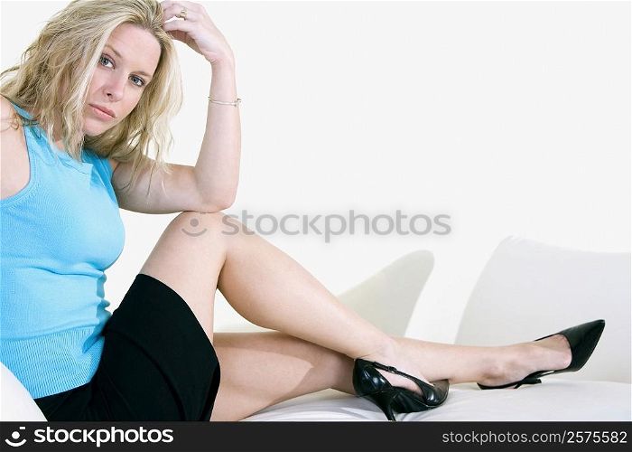Portrait of a young woman sitting on a couch