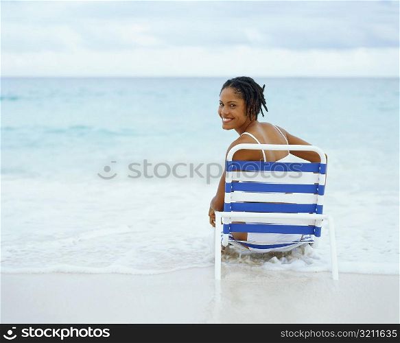 Portrait of a young woman sitting on a lounge chair, Bermuda